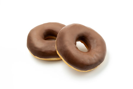 Two Donuts -Tasty dessert with chocolate glossy glaze in a plate, isolated on white background. One round chocolate doughnut cake for your design and print. Clipping pathの写真素材