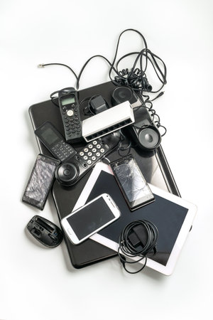 Electronic waste ready to recycle, isolated on white background.  pile of mixed electronic waste, old broken computer parts, laptops, cell phonesの写真素材