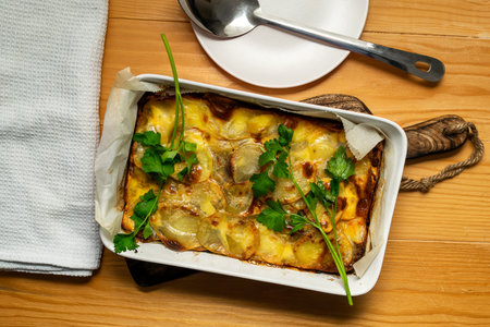 Traditional Greek potato and meat casserole with cheese - moussaka, dark background. Greek cuisine conceptの写真素材