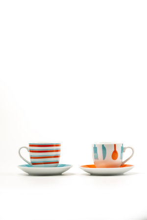 Two colorful coffee cups or mugs on white background. With copyspaceの写真素材