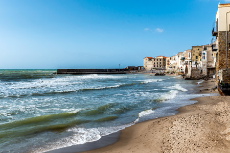 Beach and blue sea in Cefalu, town in Italian Metropolitan City of Palermo located on Tyrrhenian coast of Sicily, Italyの写真素材