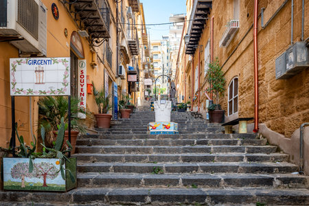 Agrigento, Sicily, Italy - May 19, 2023: Cityscape with old historical buildings, narrow street and medieval steps with colorful ceramic decorations in Agrigento, Sicilyのeditorial素材