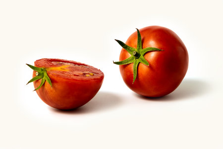 Tomatoes. Whole and a half isolated on whiteの写真素材