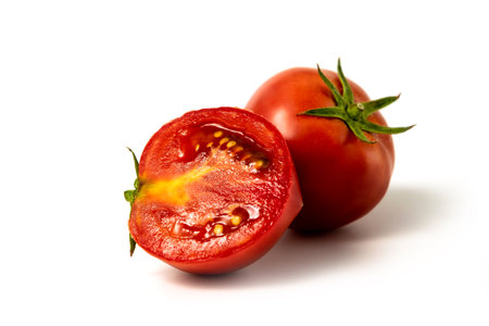 Tomatoes. Whole and a half isolated on whiteの写真素材