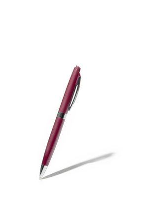 Detailed purple classic ballpoint pen writing on white surface with its shadow. Isolated on white background with clipping pathsの写真素材