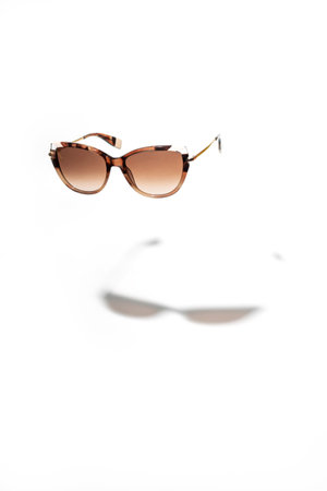 Brown female Sunglasses hovering isolated on white background. Sun glasses summer accessories as design element for promo or advertising banner.の写真素材