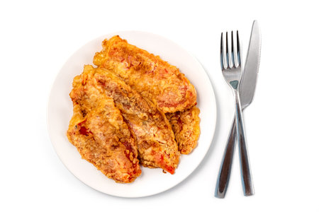 Breaded Peppers (Pohovane Paprike), Balkan cuisine specialty. Fried paprika served on a plate with knife and forkの写真素材