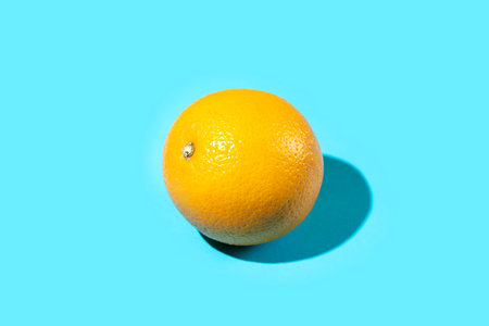 Ripe and fresh orange fruit on blue background. Vitamins Healthy Diet Summer Superfoods Concept. Food Poster Banner Template. Copy Spaceの写真素材