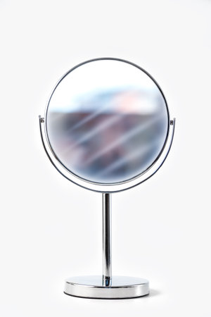 Silver makeup mirror isolated on whiteの写真素材