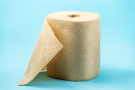 Roll of paper towels or brown tissue isolated on blue background. Recycled paper towelsの写真素材