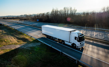 Big white delivery truck on the road with sunset countryside,fast delivery, cargo logistic and...