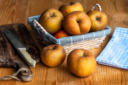 Organic apple known in Serbia as kozara in a wicker basket on an old wooden tableの写真素材