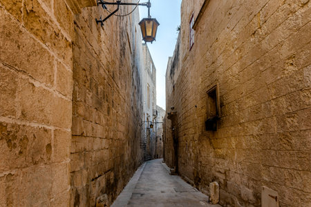 Empty street of ancient Roman city Mdina, ancient capital of Malta, fortified medieval town. Popular touristic destinationの写真素材