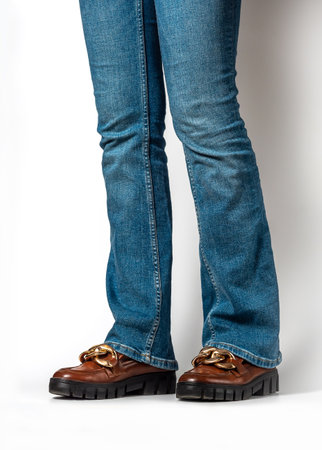 Close-up of female legs in jeans and brown casual leather shoes. Women's summer shoesの写真素材