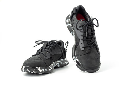 Black leather shoes isolated on white background. A pair of modern stylish black sneakers.の写真素材