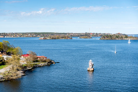 Marine signs and lighthouse in the Stockholm archipelago rocky island to help you navigate in shallow waterの写真素材