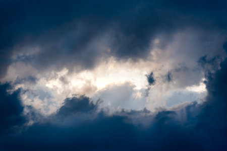 Dark and Dramatic Storm Clouds framing a clear sky Area Background