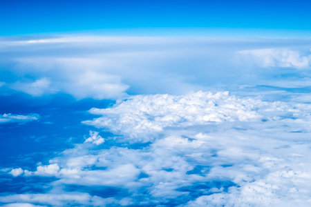 An abstract image of the sky with clouds taken from an airplane from a high angle.の写真素材