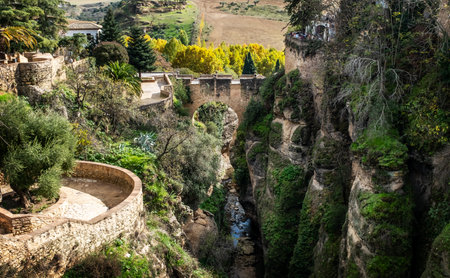View of the narrow and deep El Tajo Gorge in Ronda in Andalusiaの写真素材