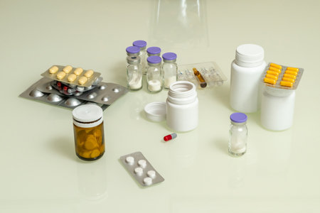 Different types of drugs or medicine on a white glass tableの写真素材