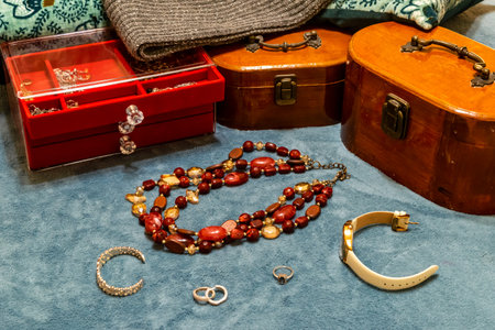 Treasure chests with various gold jewelry, bracelets, watch and pearlsの写真素材