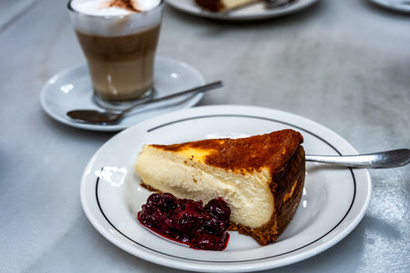 Cheese Cake served in a coffee shop with Cappuccino on a marble tableの写真素材