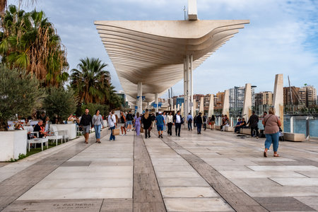 Malaga, Spain - November 15, 2024: Malaga Marina Promenade in Andalusia, Spain at sunset. People walking along the embankment Paseo Del Muelle Dos Promenade which stretches throughのeditorial素材