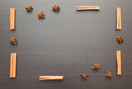 wooden background with star anise and cinnamon sticksの写真素材
