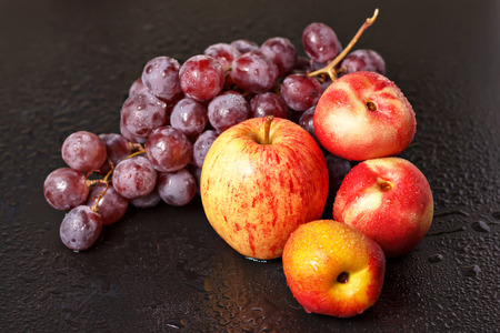 Still life of peaches of apples and grapesの写真素材