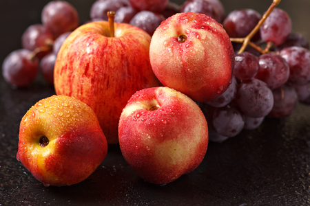 Still life of peaches of apples and grapesの写真素材