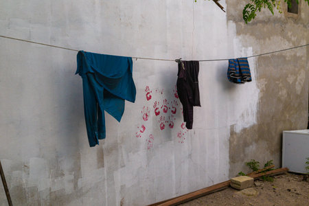 Laundry hanging on the clothesline in front of a wallの写真素材