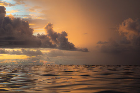 Sunset over the sea with clouds reflected in the water, Seychellesの写真素材