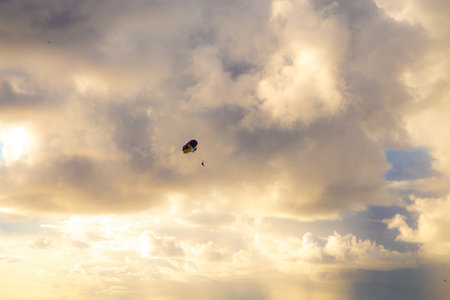 Parachute in the sky at sunset. Parachutist