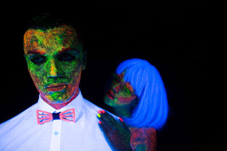 Neon photography in the rays of the ultraviolet couple in love guy and girl bride with the groom at the wedding UV radiationの写真素材