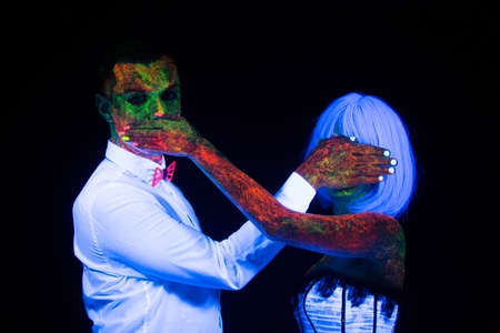 Dont say dont watch sign Neon photography bright colorful on a dark background in ultraviolet rays, couple in love guy and girl bride with groom at a wedding UV radiationの写真素材