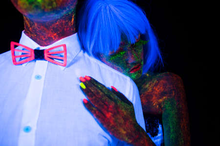 Neon photography in the rays of the ultraviolet couple in love guy and girl bride with the groom at the wedding UV radiationの写真素材