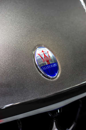 Minsk, Belarus May 2018 brand maserati emblem logo sign on auto during autoexhibition on gray...