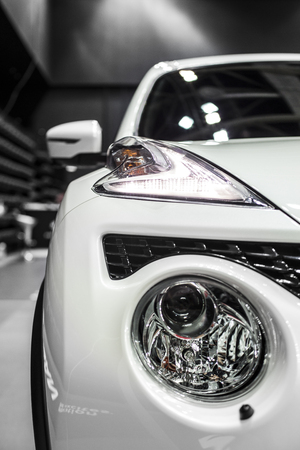 headlight of white modern car with led and xenon opticsの写真素材