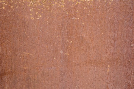 red wall with scuffs and rust pattern texture backgroundの写真素材