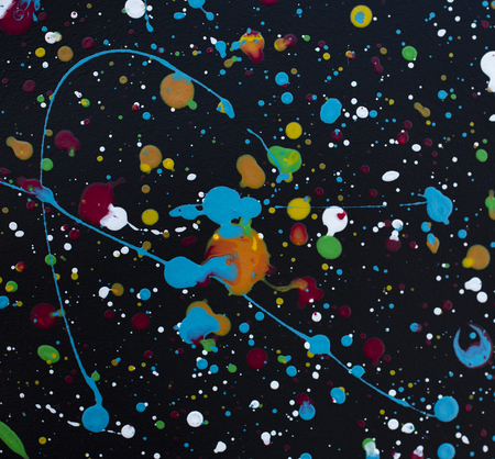 bright color paint stains and drops on a dark background abstract pattern texture background macro shotの写真素材