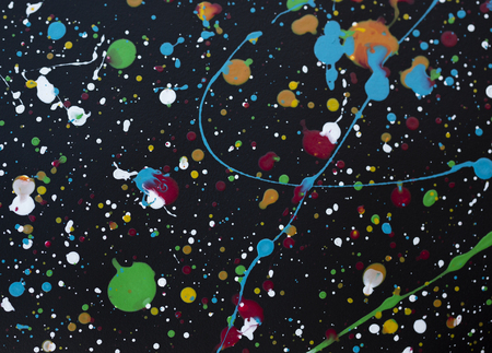 bright color paint stains and drops on a dark background abstract pattern texture background macro shotの写真素材