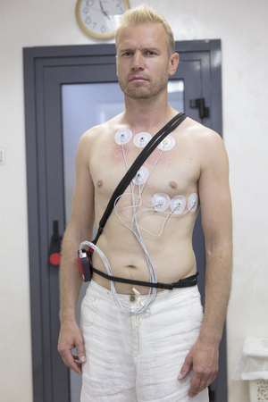 electrocardiogram equipment making cardiogram test to male patient in hospital clinicの写真素材