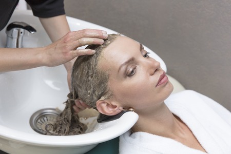 Hair beauty care, moisturizer application, hairdresser, hair mask of a beautiful girl, natural, health and beauty, closeupの写真素材