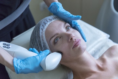 Beautiful woman in professional beauty salon during photo rejuvenation procedureの写真素材