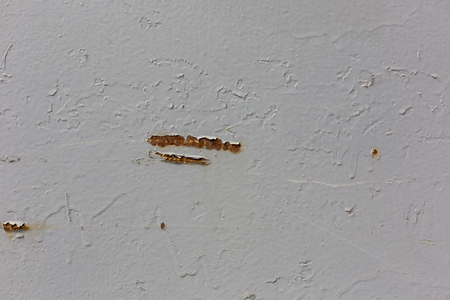 a rusty scratch on the wall pattern texture backgroundの写真素材