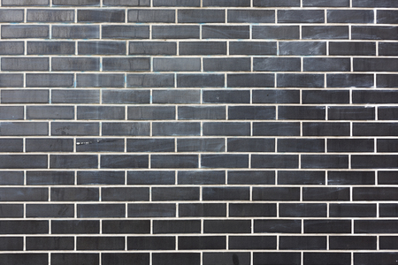 stone black bricks with white seams wall horisontal pattern texture backgroundの写真素材