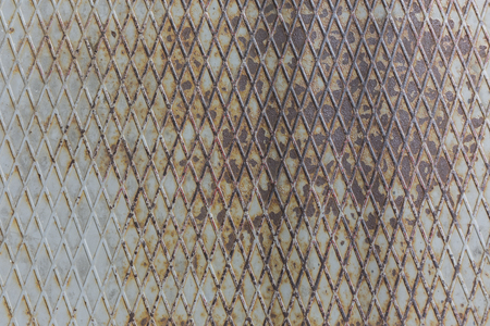 rusty embossed metal surface with old paint abstract pattern texture backgroundの写真素材