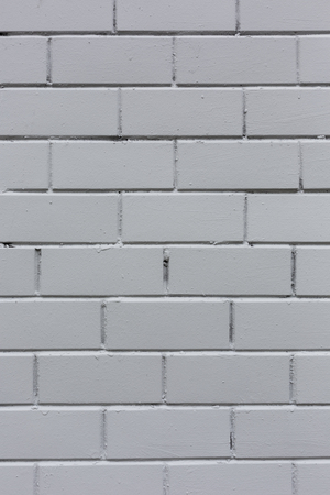 White painted vetrical stone bricks wall pattern texture background close-upの写真素材