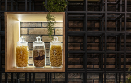 pasta and spaghetti on a shelf in a glass jar in a modern interiorの写真素材