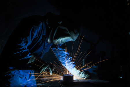 Industrial Worker in mask at the factory welding closeupの写真素材